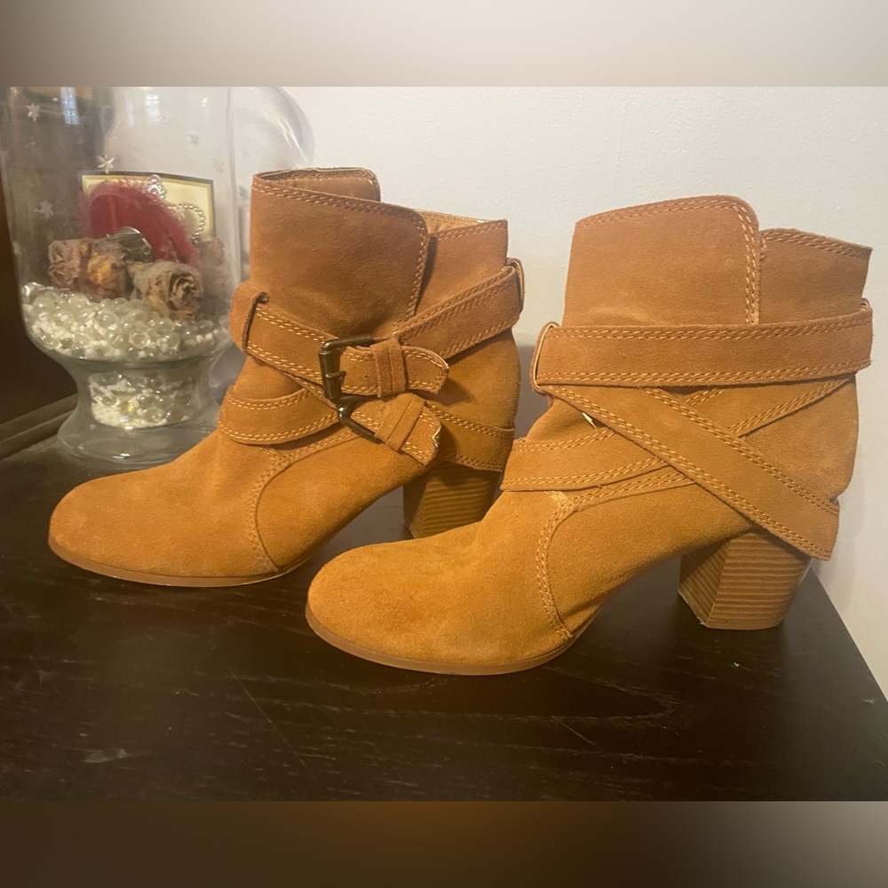 Brown heeled booties with adorable buckle strap accent.